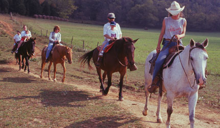 A line of people on horseback at Jesse James Riding Stables.